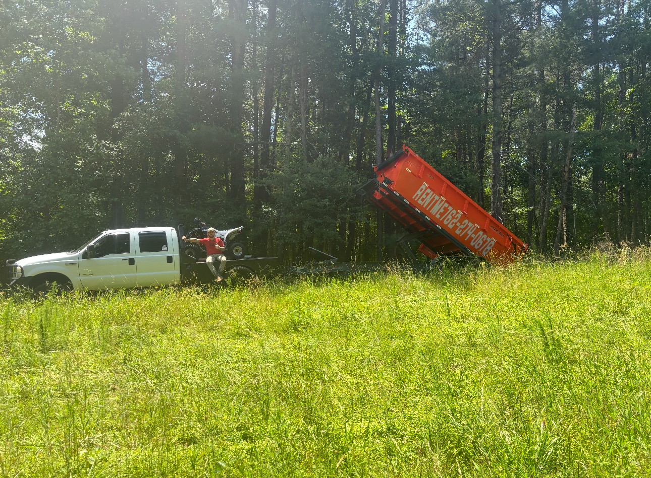 Dumpster being dropped off from trailer